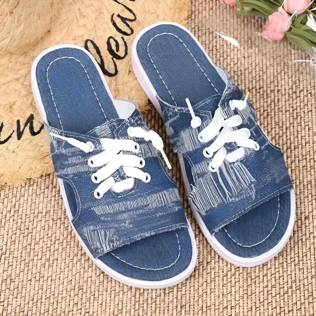 Blue Roman-style canvas slippers with flat rubber soles and cloth upper