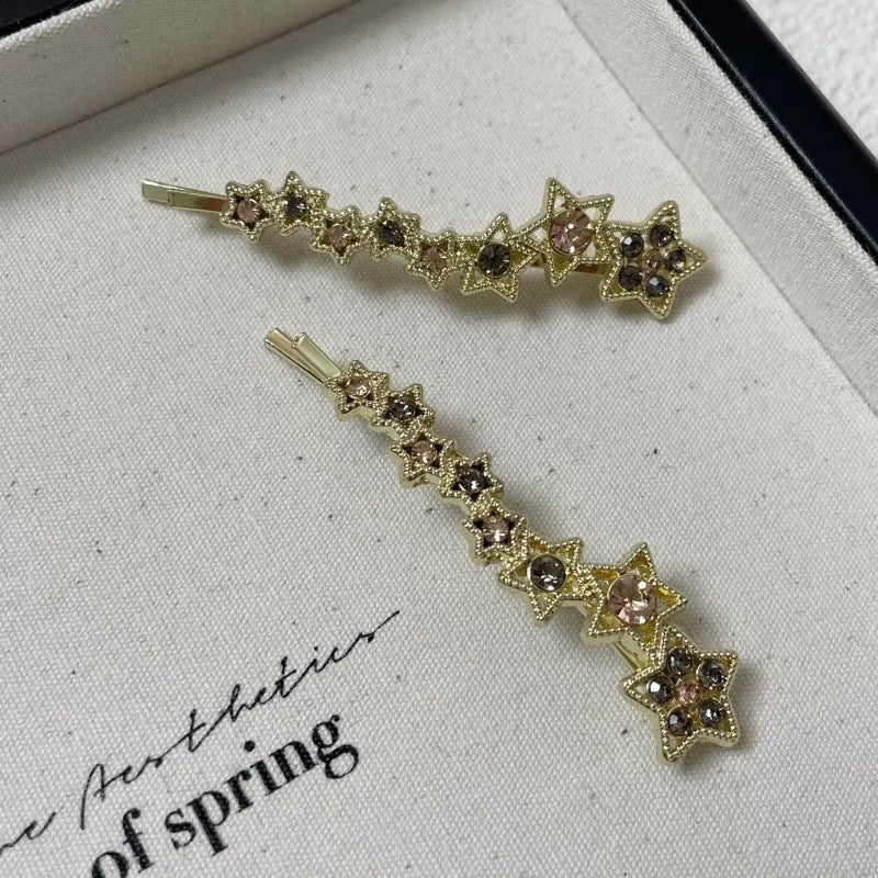 Korean style gold electroplated alloy hair barrette featuring a five-pointed star and word design.