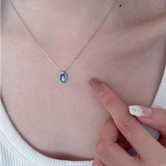 Women's navy blue geometric water drop pendant on an adjustable silver-toned chain.