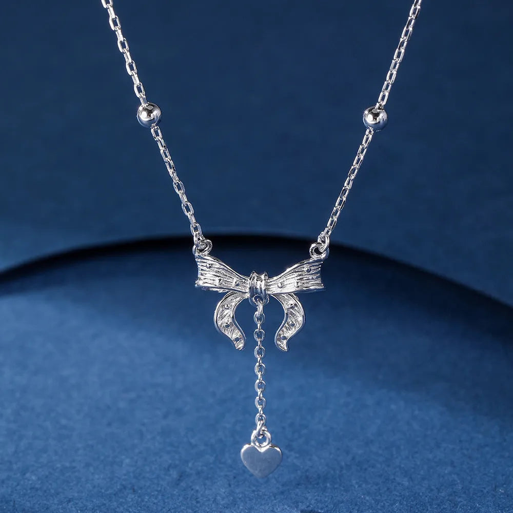 S925 sterling silver adjustable clavicle chain with a heart and butterfly pendant.