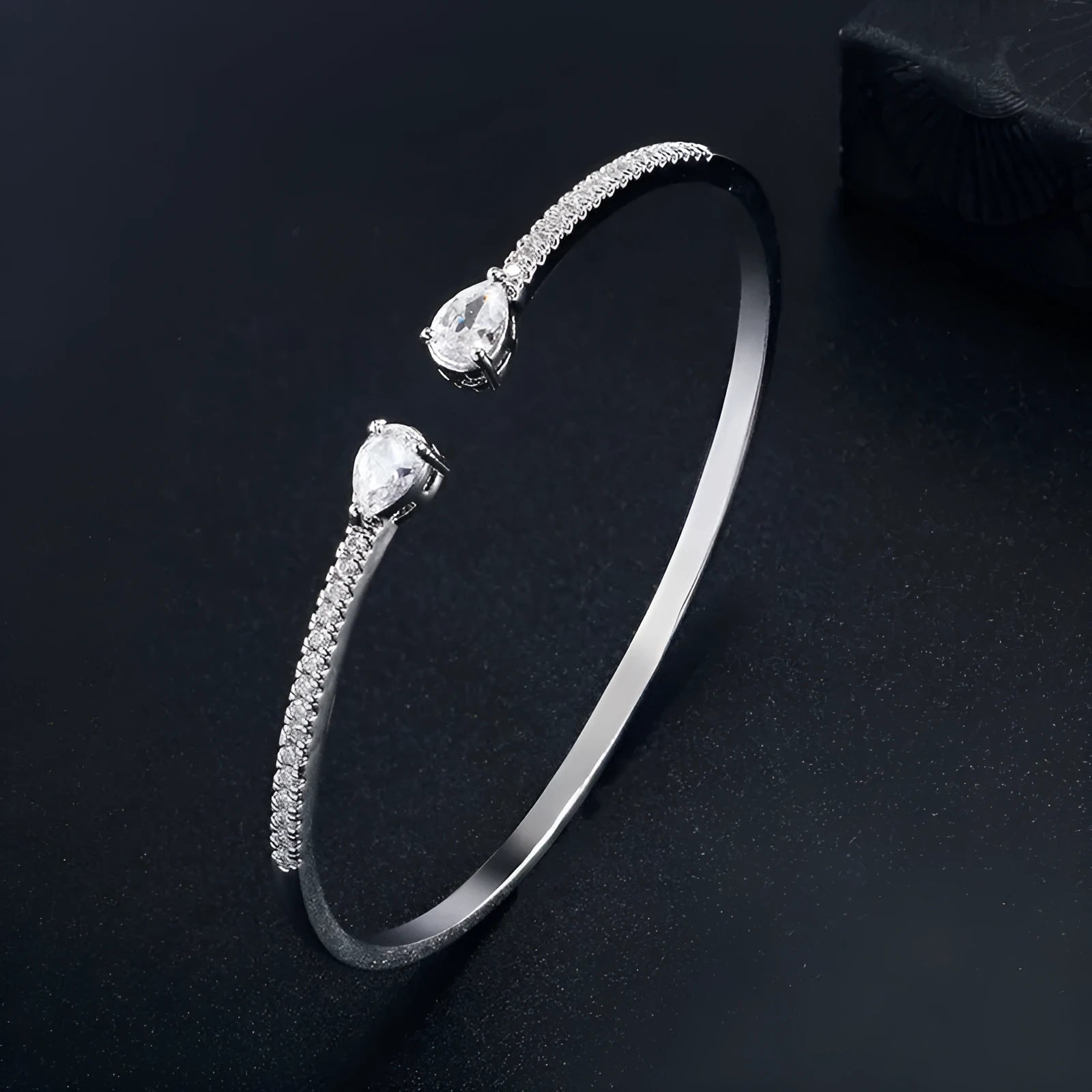 Copper fashion bracelet with multi-zircon inlay decoration, shown in white and blue colour options.