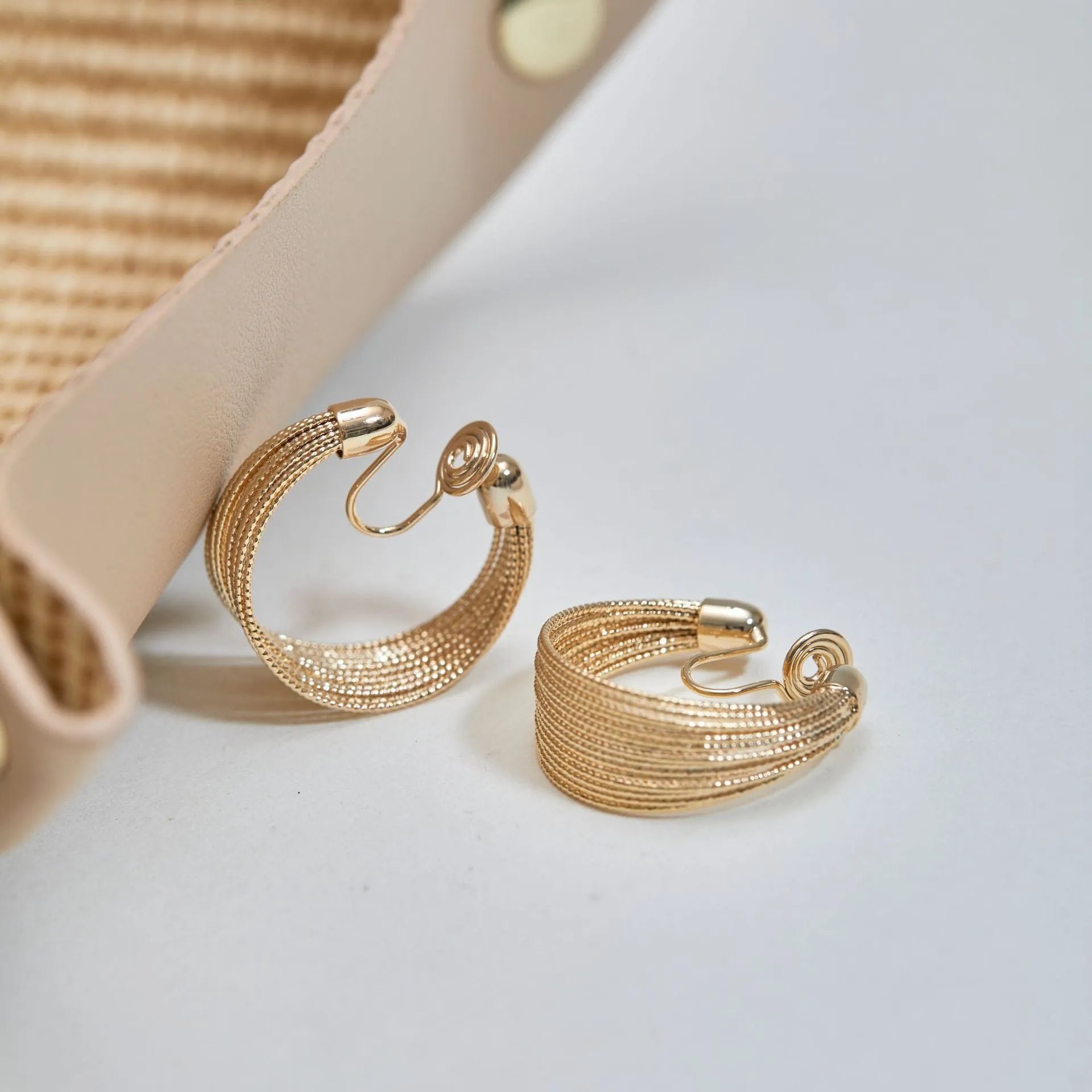Multi-layer geometric earrings in gold and silver with stud and clip style options