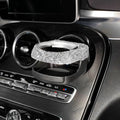 Car interior water cup bracket with decorative diamond accents mounted on air vent