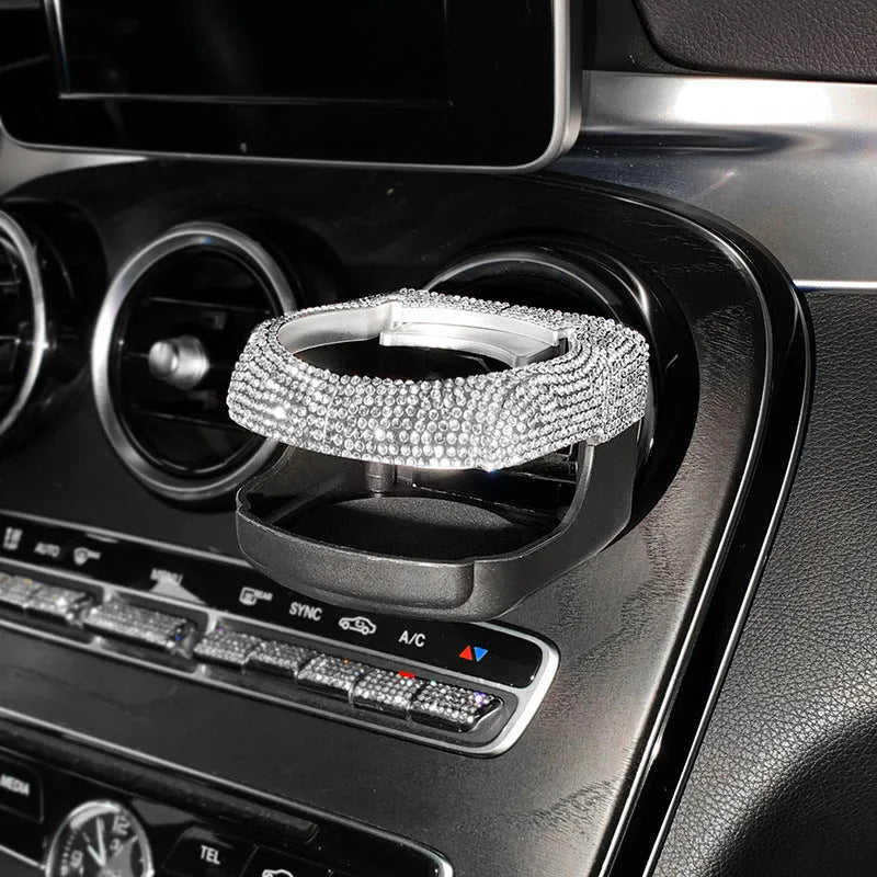 Car interior water cup bracket with decorative diamond accents mounted on air vent
