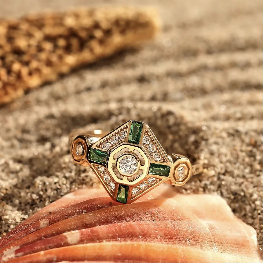 Square geometric women's ring with a lvzuan colour gemstone centrepiece on a plain background.