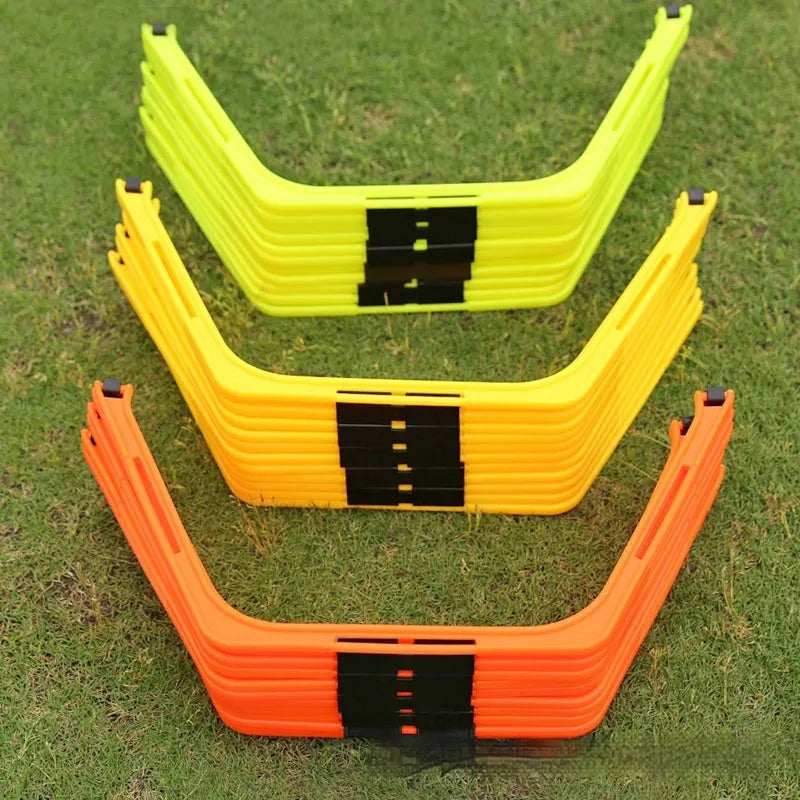 Set of six bright green, orange, and yellow foldable hexagon football agility training rings laid out on grass.