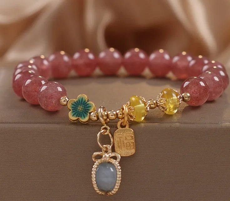 Red women's beaded bracelet with natural strawberry quartz stones, alloy metal, and rhinestone details.