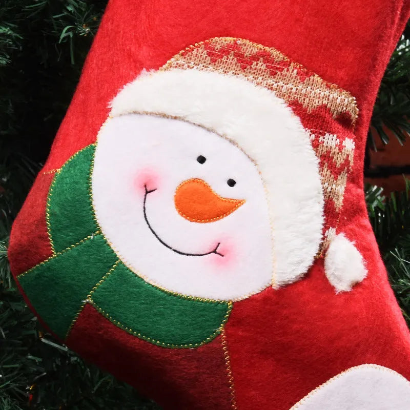 Set of three Christmas stocking ornaments with snowman, elk, and elderly figure designs