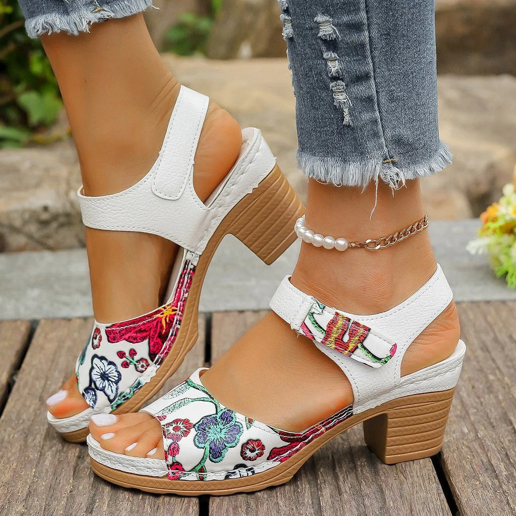 White women's casual high heel sandals with a Velcro strap buckle on a rubber sole.
