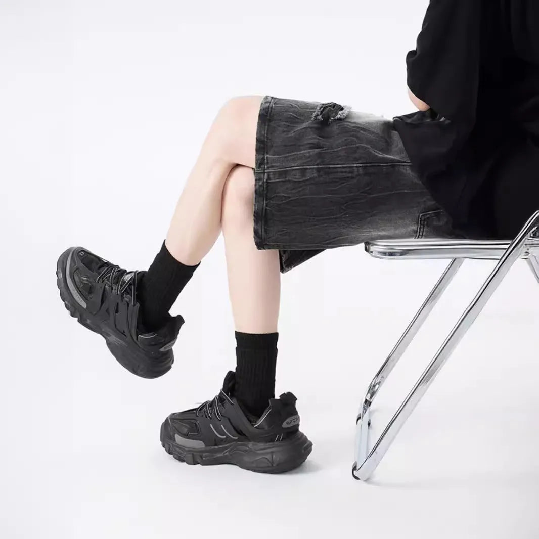 Men's loose fit distressed denim shorts with ripped knee detailing in retro style