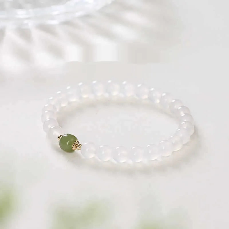 A handmade white agate style crystal bracelet with cinnabar inlay, shown in 6mm and 8mm bead sizes.