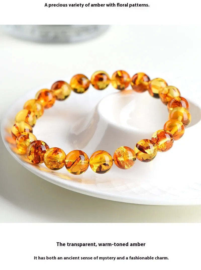 Natural yellow piebald amber beaded bracelet with geometric polished beads on a white background.