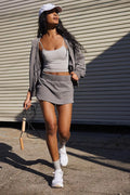 Women's grey hooded jacket and matching miniskirt street style co-ord outfit