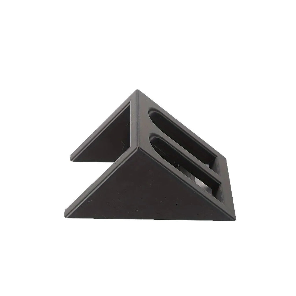 Matte black plastic pistol display stand with a punk-style design on a flat surface.
