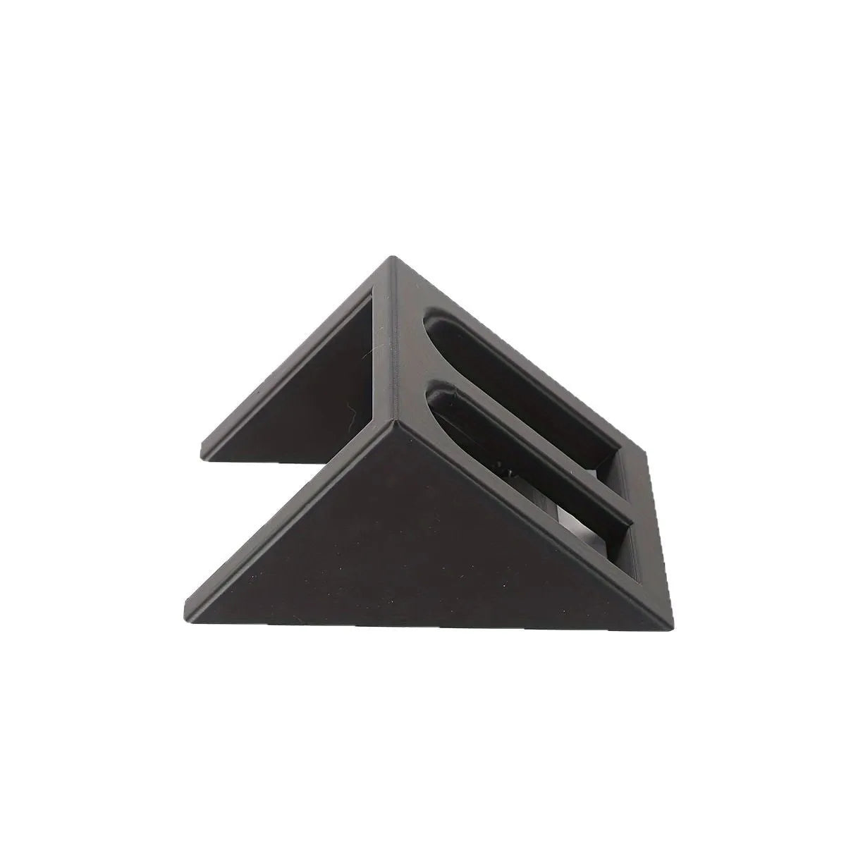 Matte black plastic pistol display stand with a punk-style design on a flat surface.