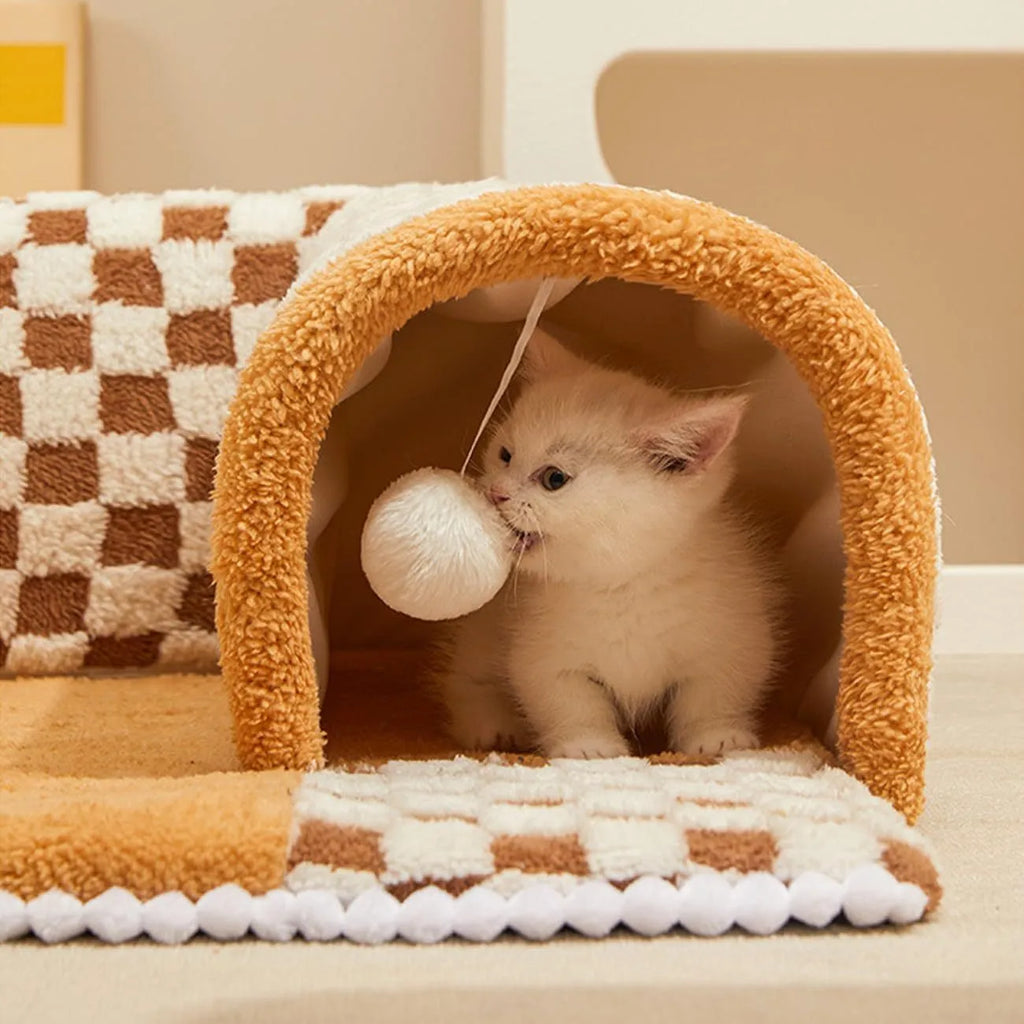 Fan-shaped plush pet bed with central play tunnel in plaid design, shown in coffee colour.
