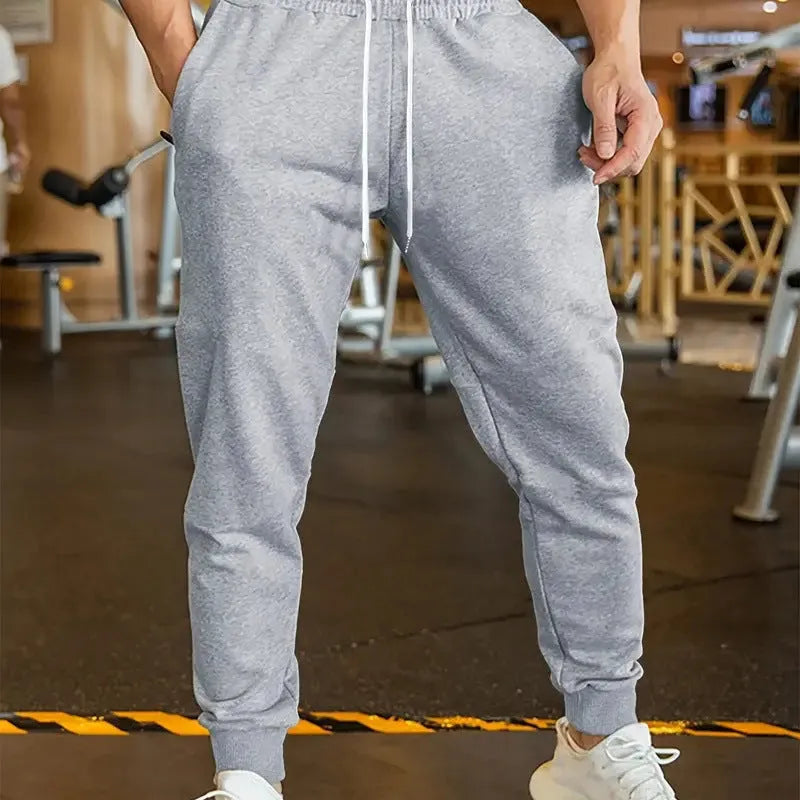 Men's elastic waist leisure trousers with drawstring closure and loose fit in polyester fabric