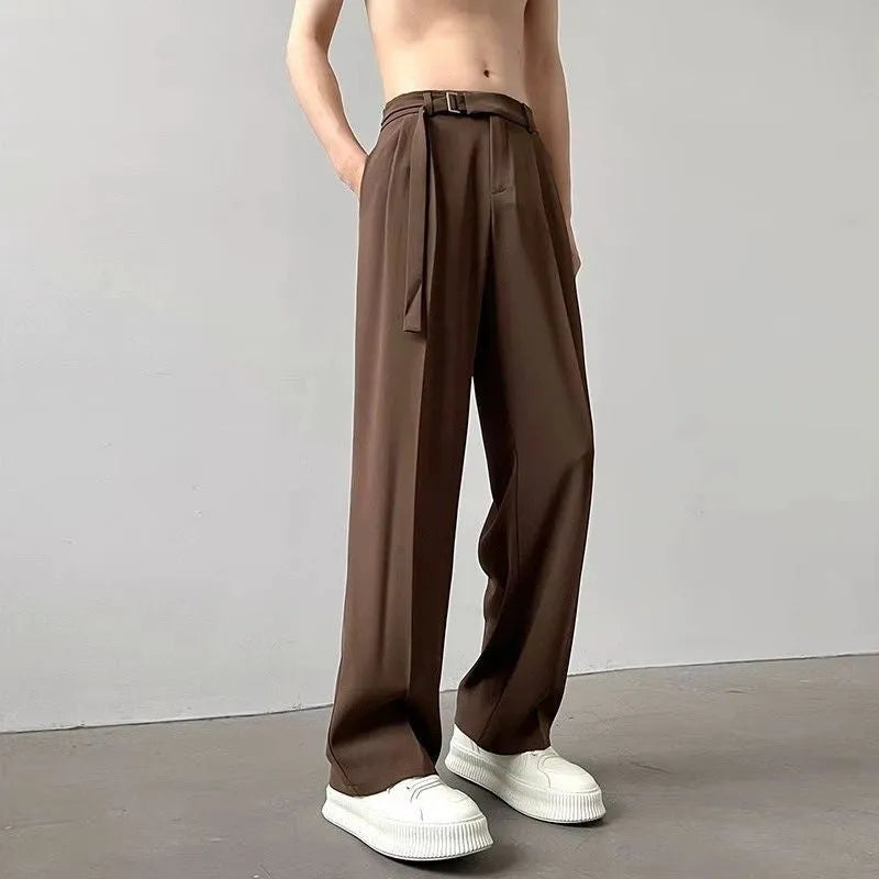 Man wearing thin straight-cut wide leg casual trousers in black, showcasing the loose fit and straight leg opening.