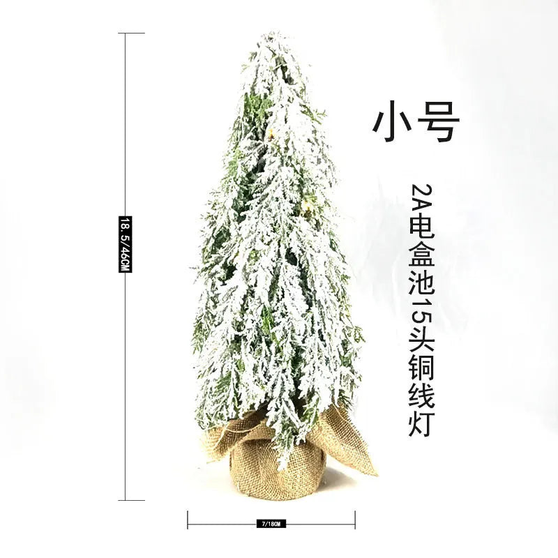 Small 24-inch white plastic Christmas tree with lights and snow sprayer decoration