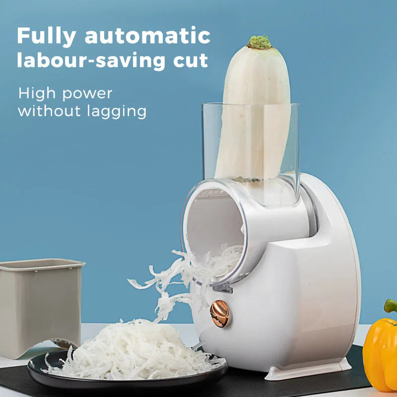 White electric vegetable slicer with rotary grater, feeding port, and three blade pairs on kitchen counter