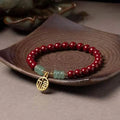Wave-shaped bracelet with cinnabar segments and copper beads in national style design