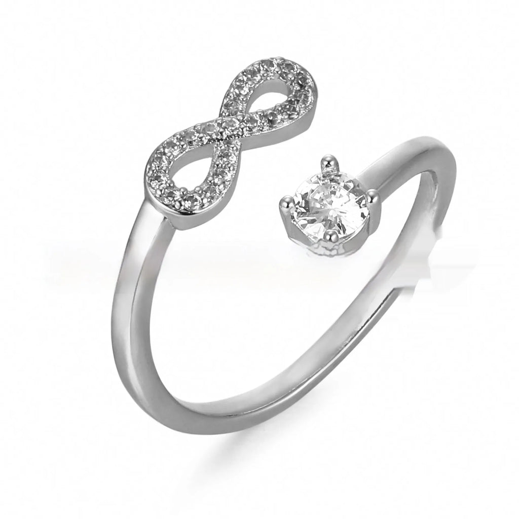 Geometric metal ring with zircon-inlaid initial letter charm in gold, rose gold, or silver.