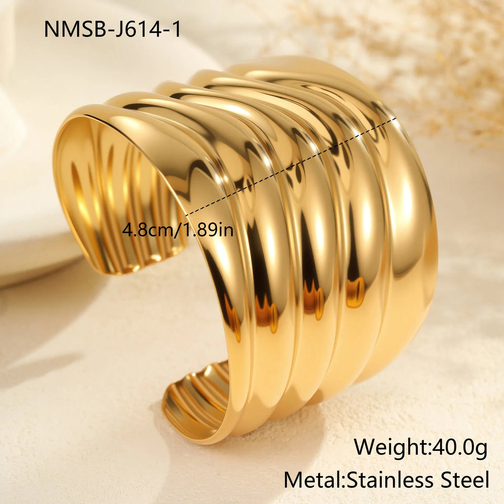 Women's wide fashion bracelet with gold plating and geometric wave design