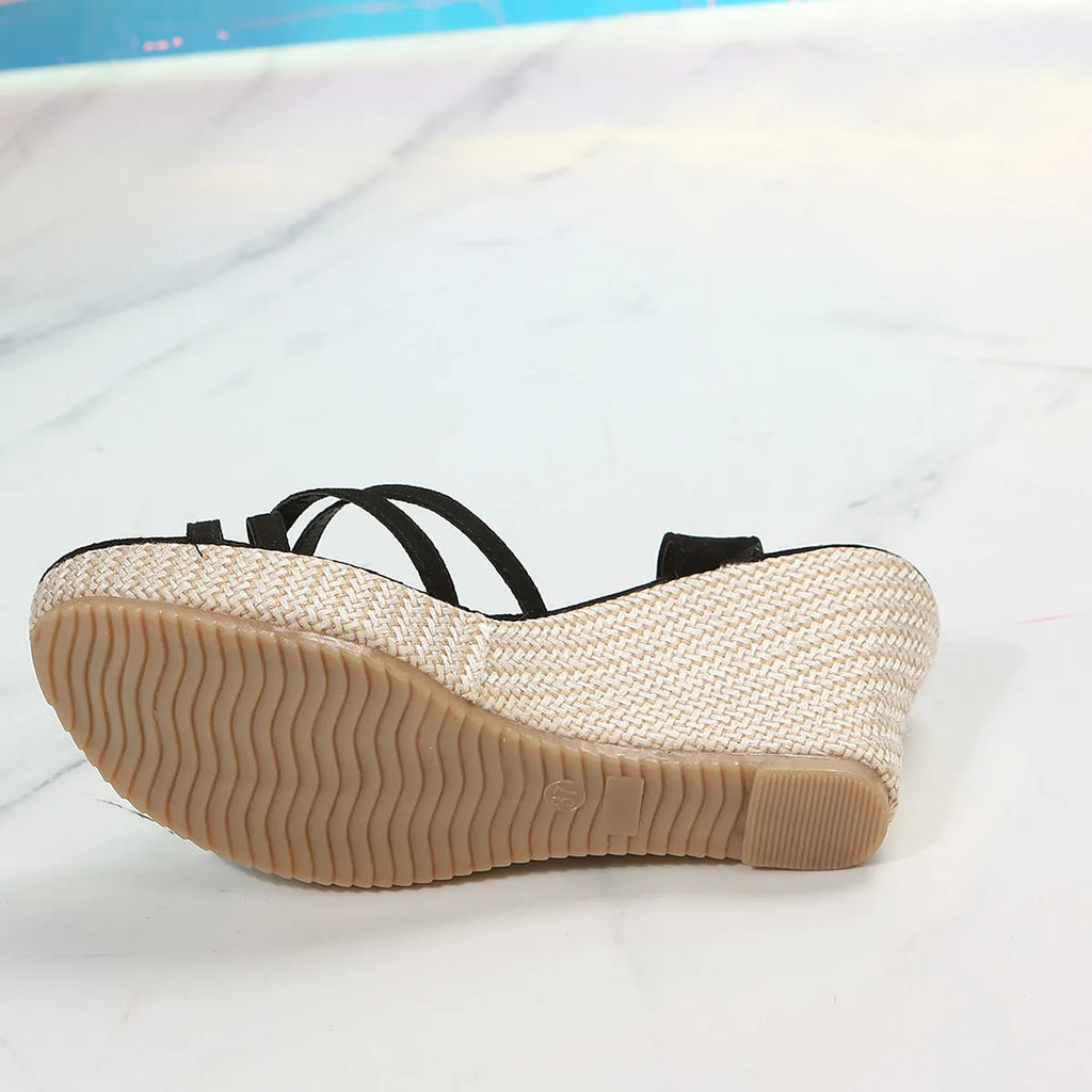 Beige and black women's wedge sandals with a cloth upper and fish mouth toe opening.
