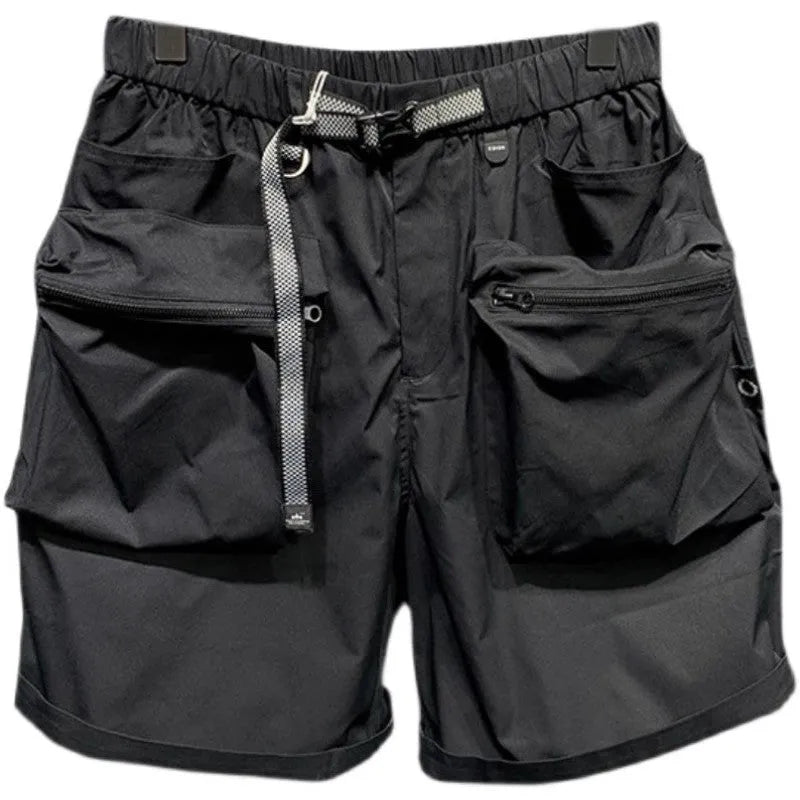 Men's loose-fit black work shorts with pockets, shown on a model, above the knee length.
