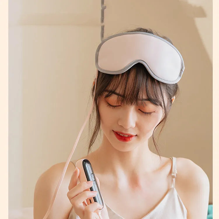 Pink and green portable Eye SPA mask with steam heat and vibration massage functions.