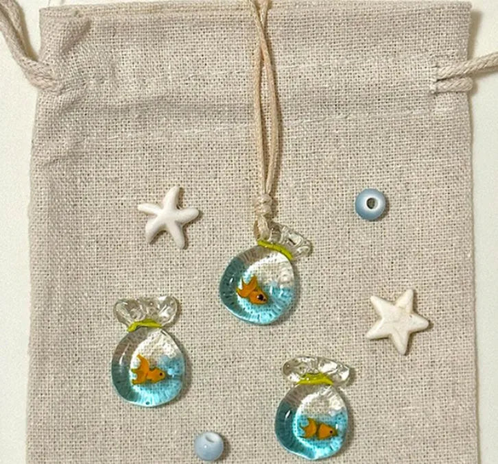 Women's coloured glaze small fish lucky bag pendant on a cotton linen clavicle chain necklace.