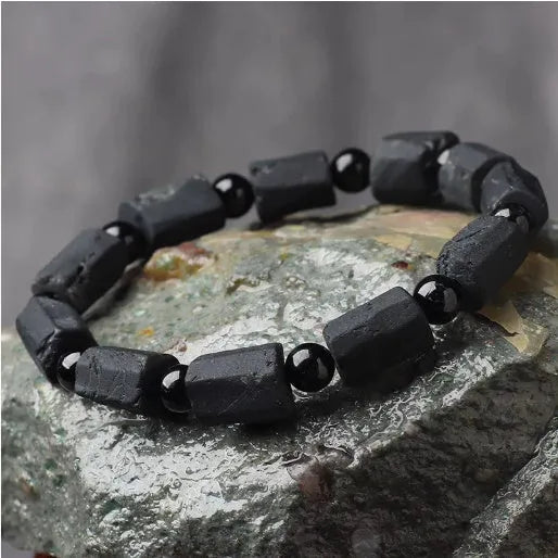 Natural black tourmaline rough stone bracelet with approximately 9mm beads on wrist