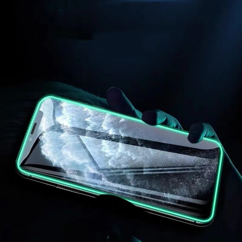 Luminous full cover tempered glass screen protector glowing green in the dark for iPhone.