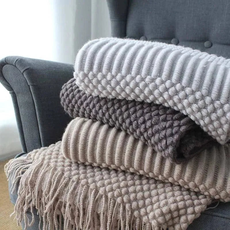 Small grey polyester fibre blanket folded to show its texture and colour.