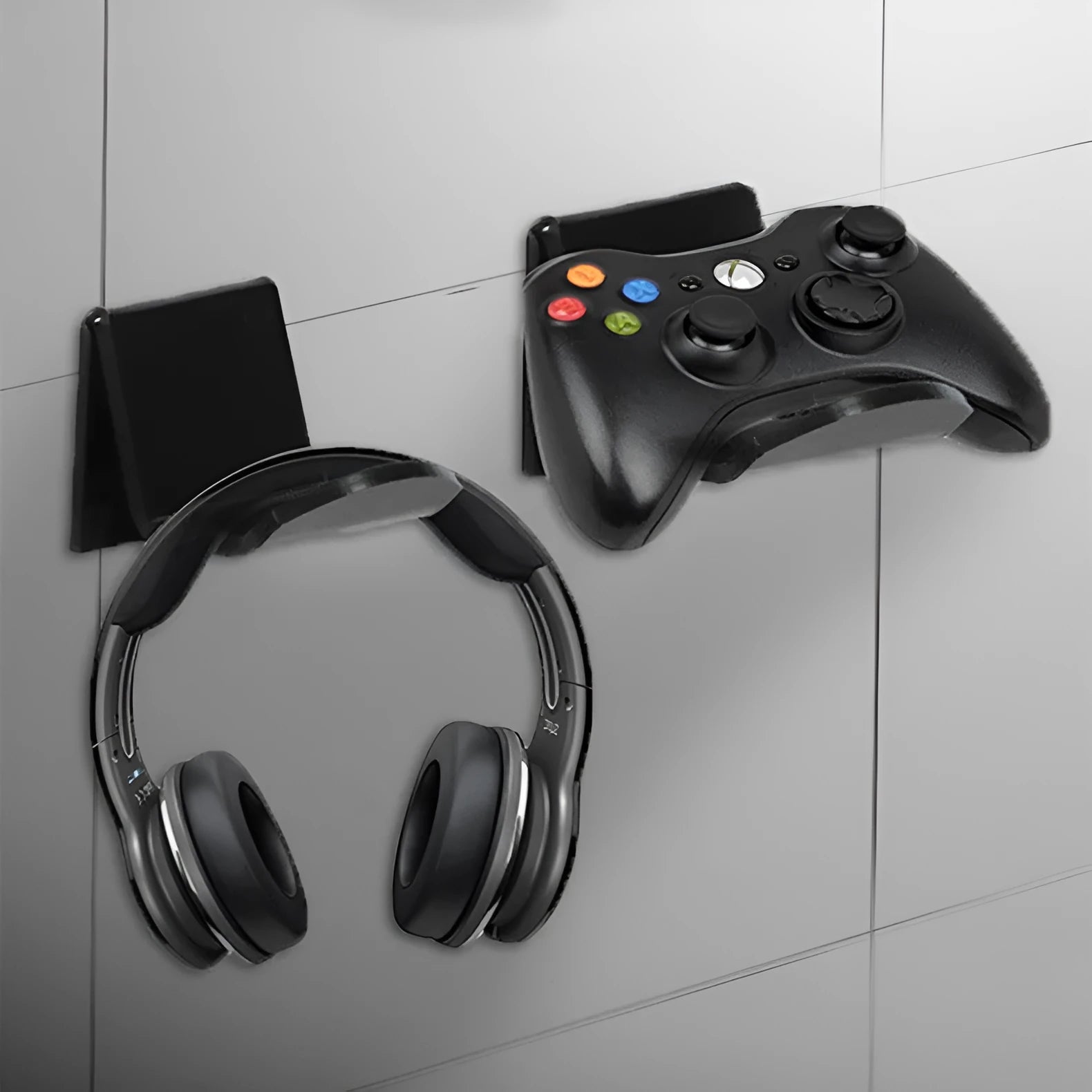 A universal plastic wall mount bracket for game controllers, shown in black colour