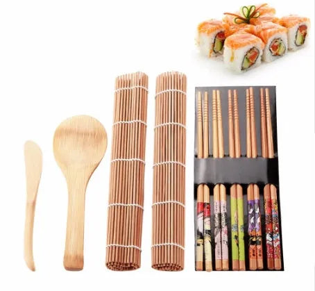 White plastic sushi tool set with moulds for rolls and Nigiri and a rice paddle on a light background
