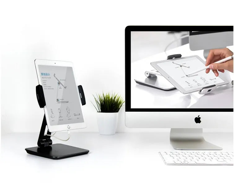 Black folding aluminium desktop stand holding a tablet at an angle, showing 360° rotation and silicone grips.
