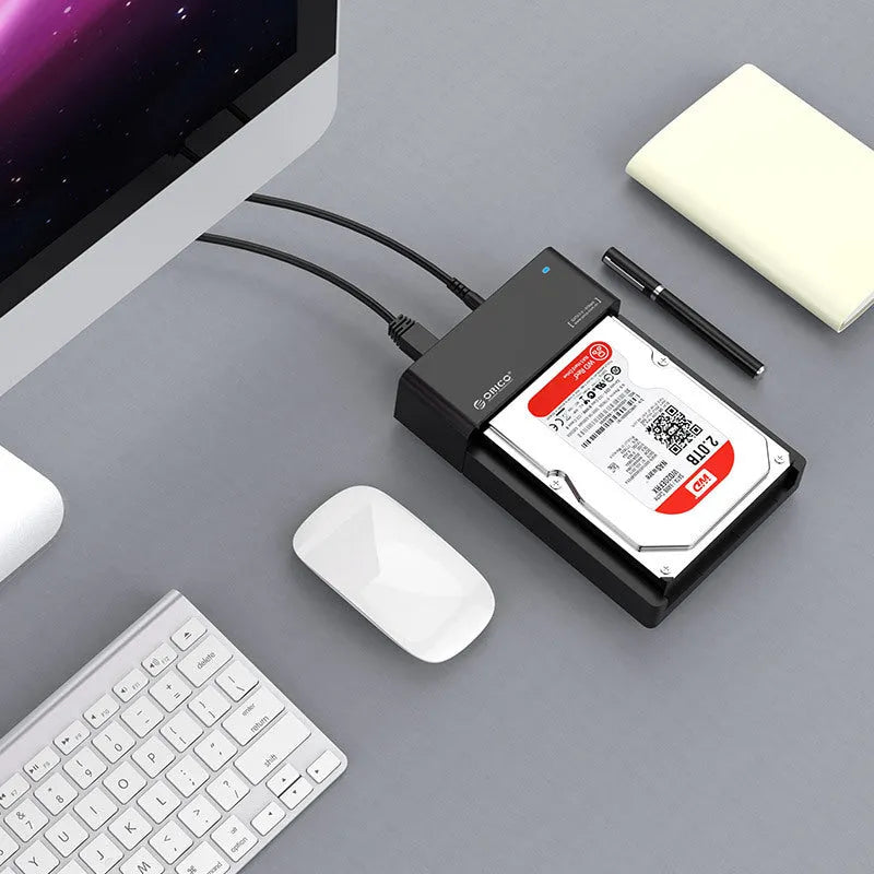 Black universal SATA hard drive enclosure for 2.5-inch and 3.5-inch drives with data cable.