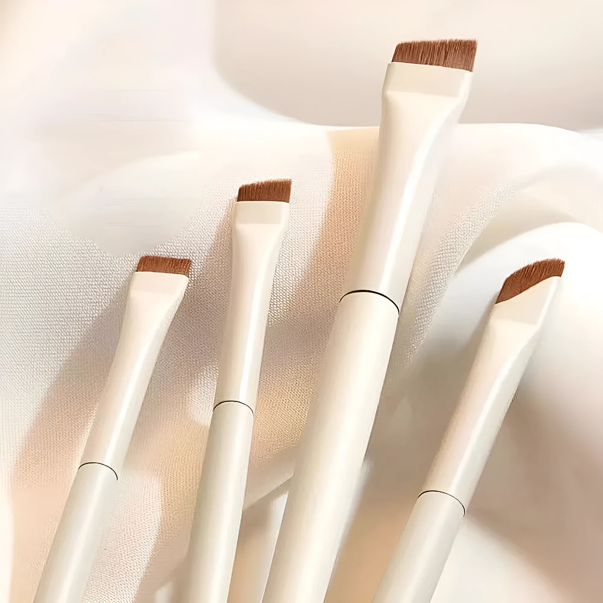 Four angled eyeliner and brow brushes with ultra-thin precision tips in leather case