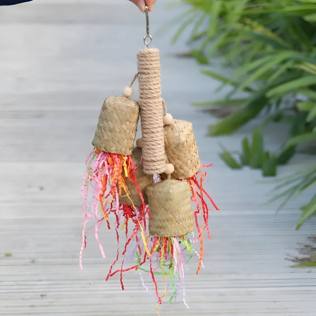 Colourful shredded paper hanging bird toy made of wood and sisal for parrots.