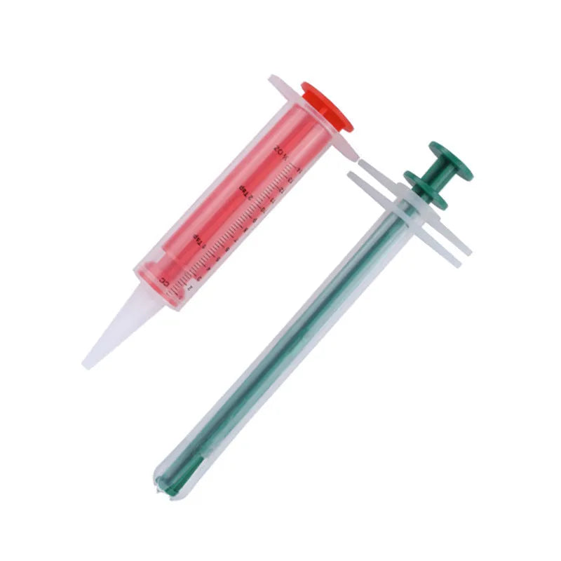 Two pet pill shooter syringes with soft silicone tips for administering medication to cats and dogs