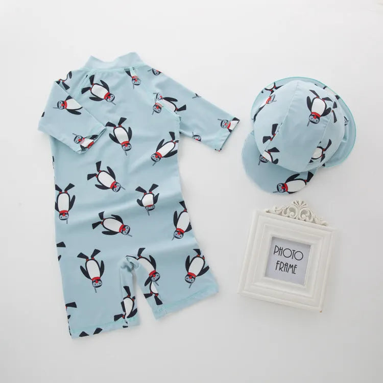 Boy's penguin print long sleeve swimsuit with matching swimming cap set on white background