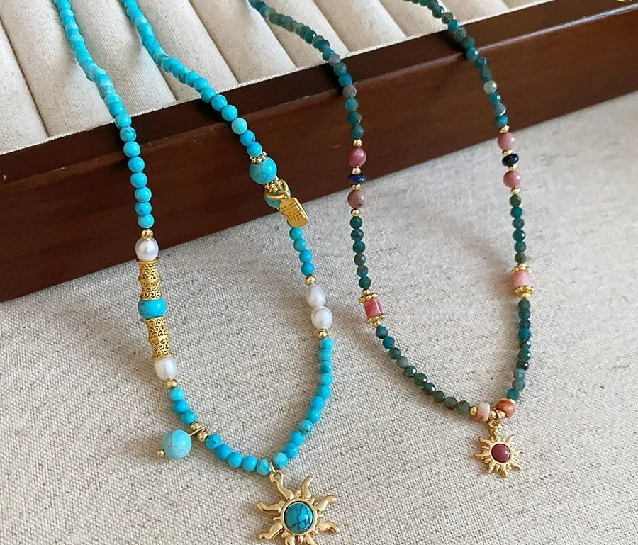 Freshwater pearl necklace with a geometry-shaped stone sun pendant on an electroplated chain.