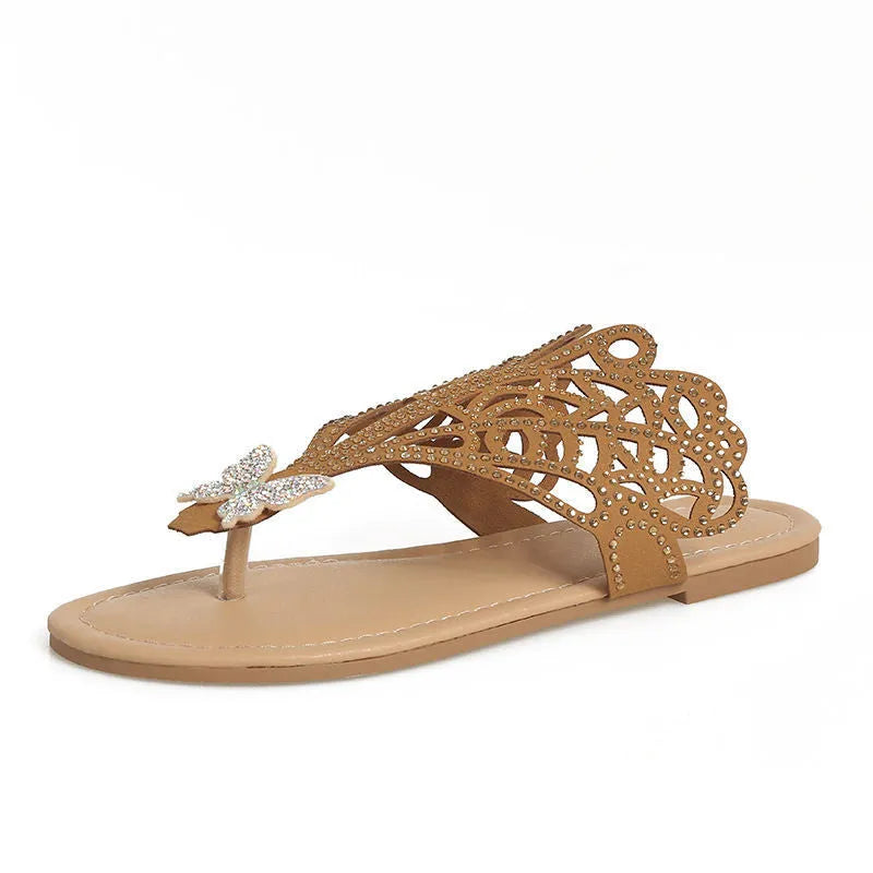 Women's black slip-on sandals with rhinestone details on flip-toe hollow design.