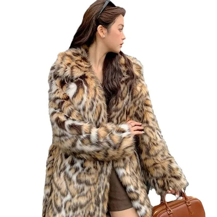 A model wearing a black faux fur mid-length coat with a large fur collar and front pockets.