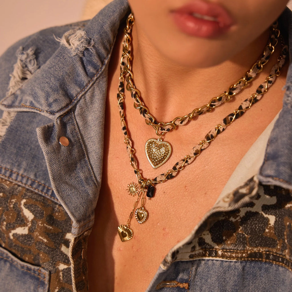 Leopard Love stainless steel necklace with geometric heart or sun pendant on a gold plated adjustable chain.