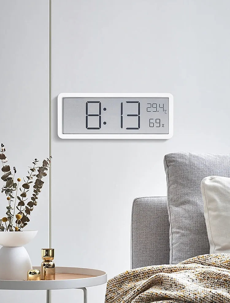 Simple large screen temperature and humidity clock with plastic shell in white Nordic style on a desk