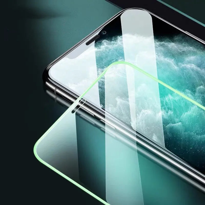 Luminous full cover tempered glass screen protector glowing green in the dark for iPhone.