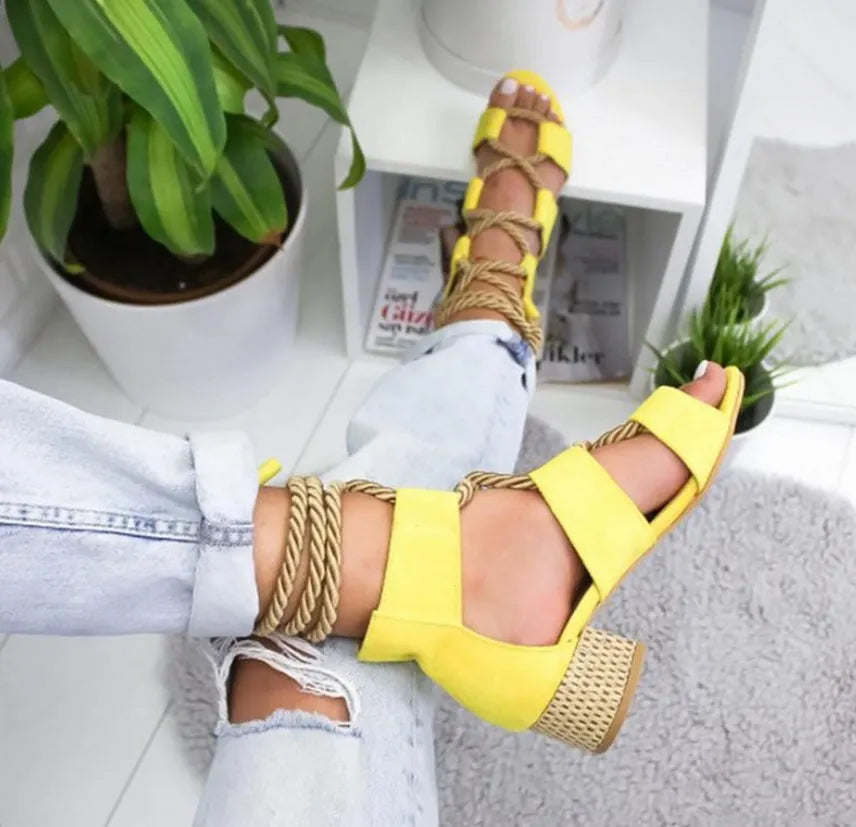 Women's beige suede sandals with a fish mouth toe, front strap, and ankle strap, featuring a thick middle heel.