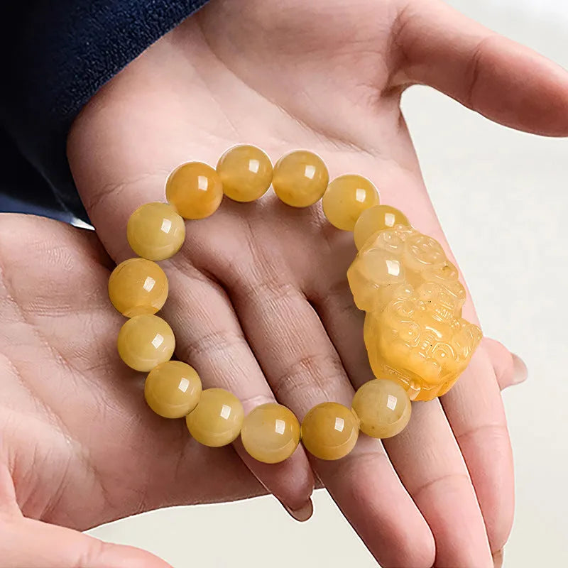 Carved golden thread jade money bracelet showing detail, available in large and small sizes with unisex design.